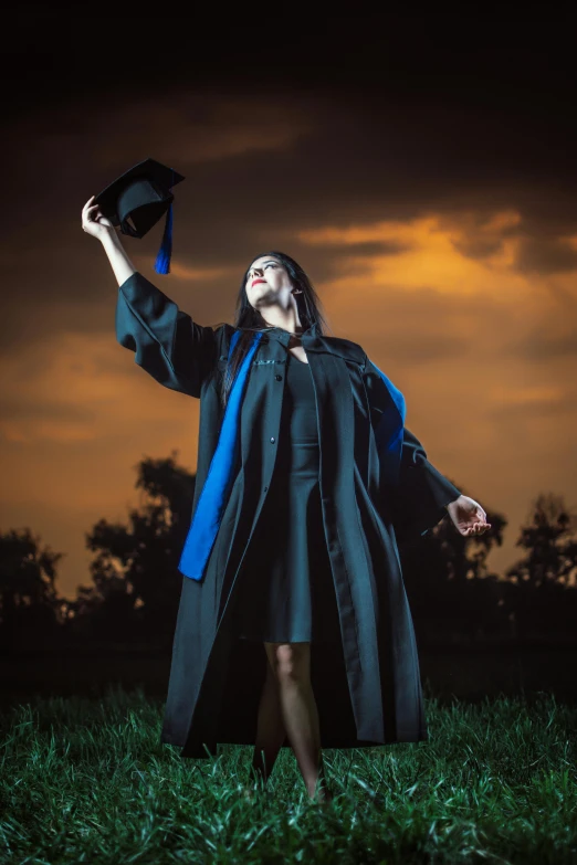 a woman in a gown is dressed as a graduate