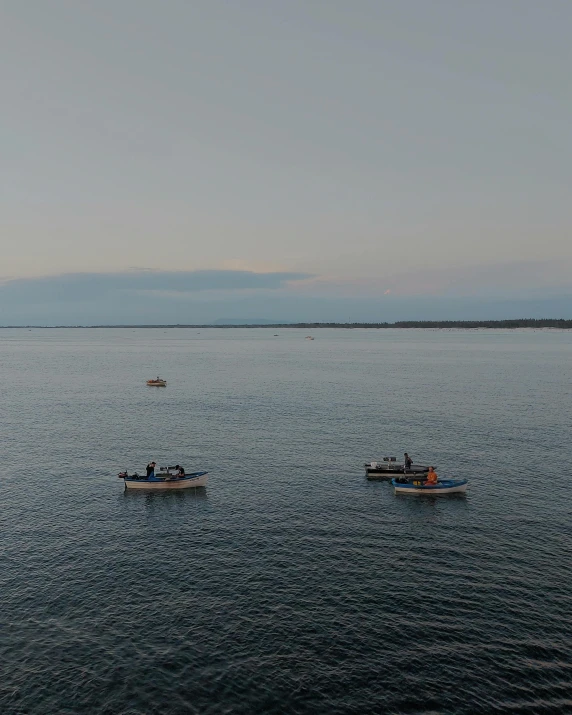 two boats floating on the water next to a town