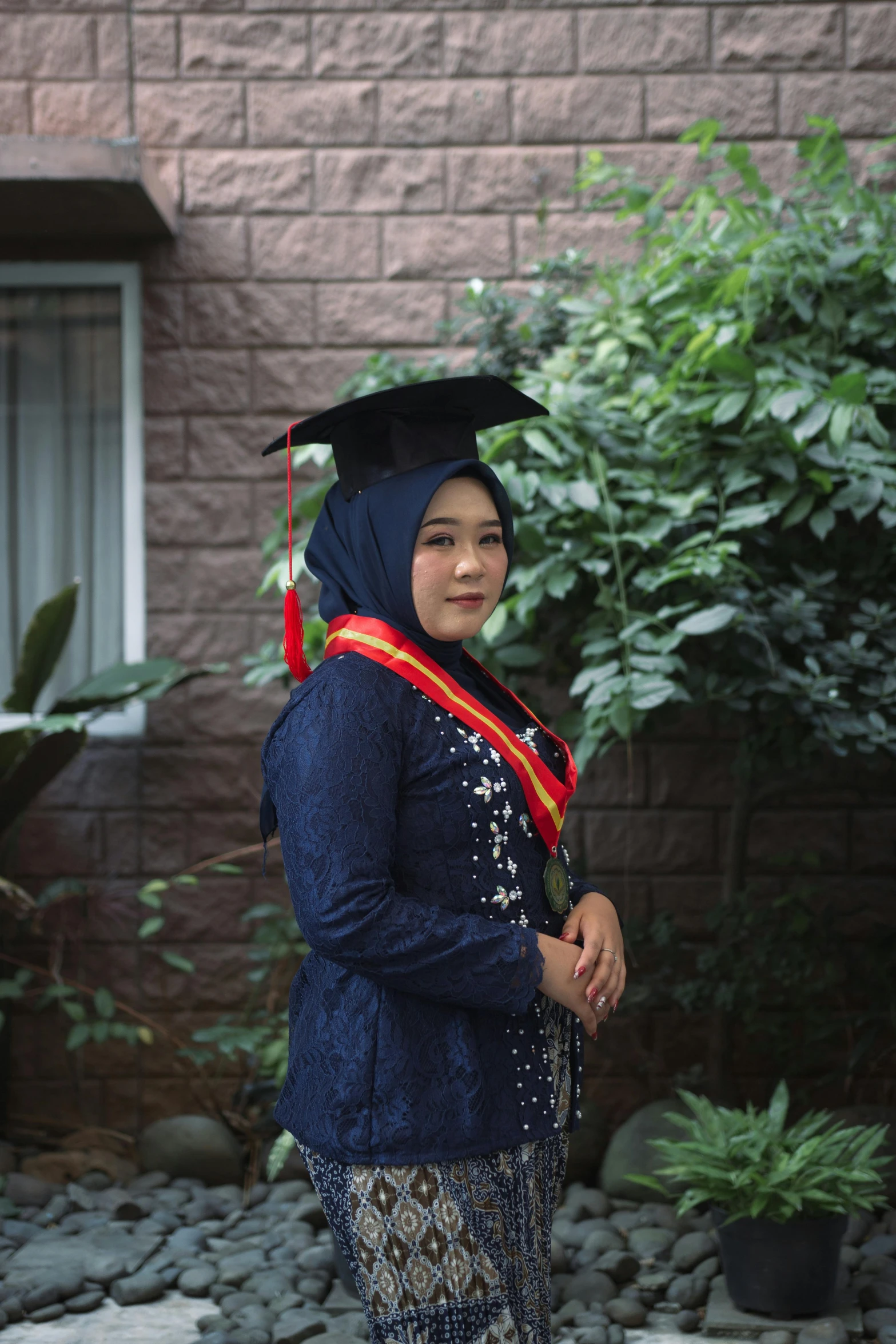 a girl with a graduation gown and a diploma hat on