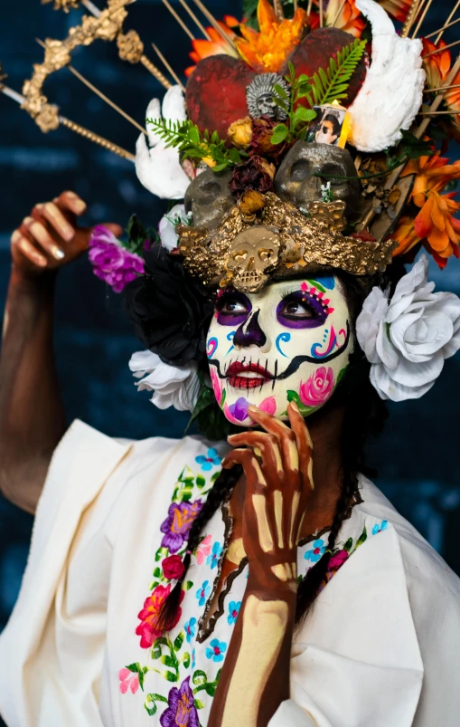 a woman with white makeup and floral headdress