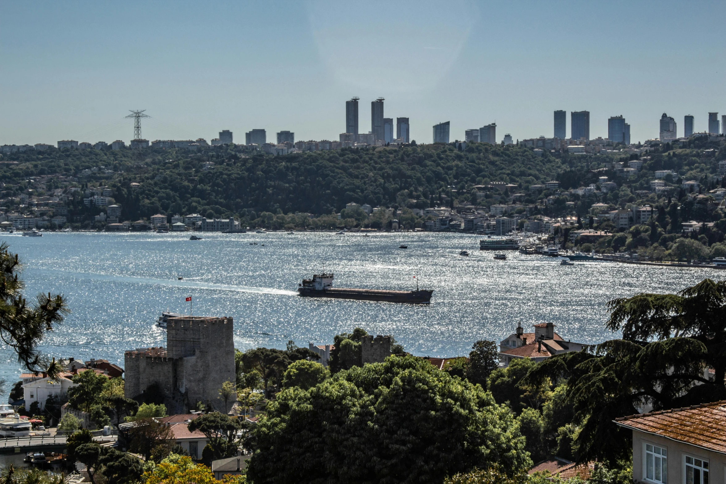 the bay in the city with a large boat sailing around