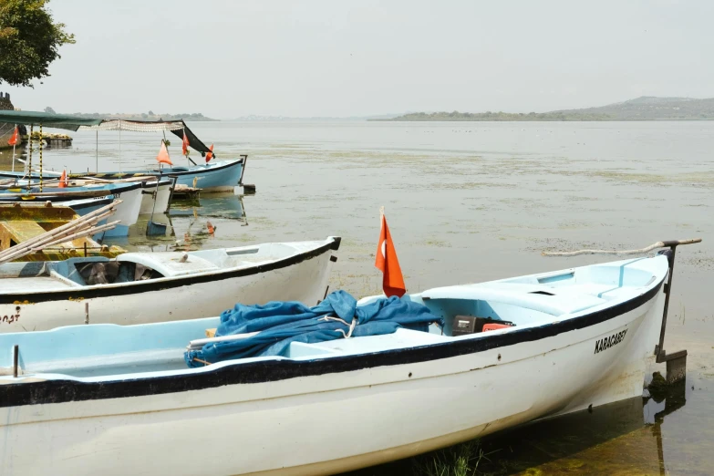 several boats sitting in the water near one another