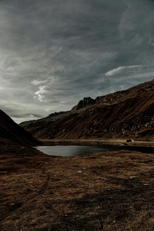 a large body of water sitting between two hills