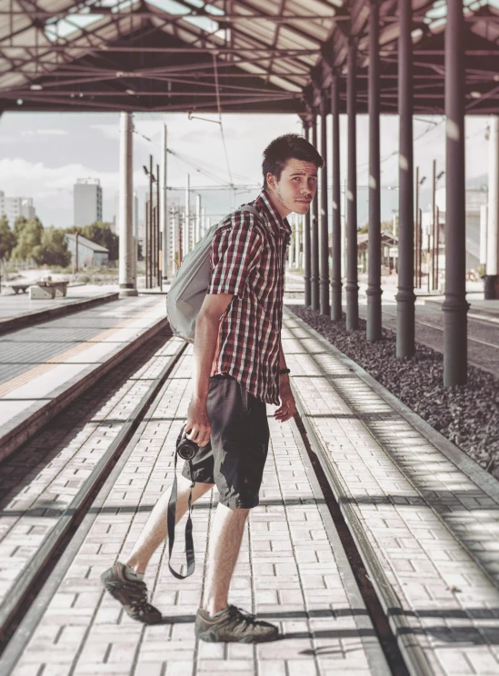 a man is walking down the train tracks