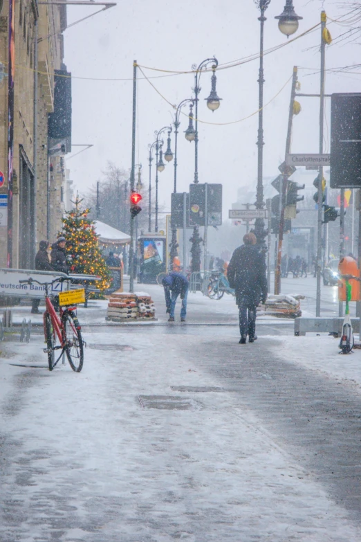 snow covered street in an urban city with pedestrians