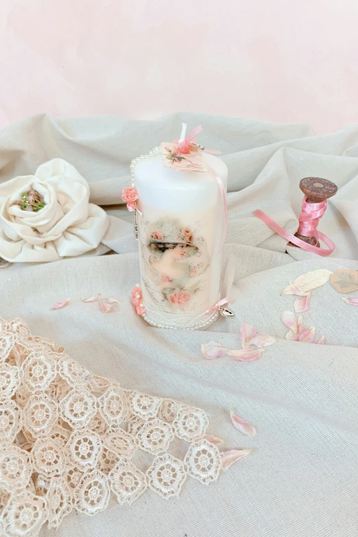 a candle and an antique handicture on a table