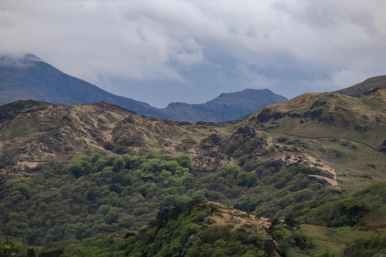 an area that has mountains covered in greenery on either side of it