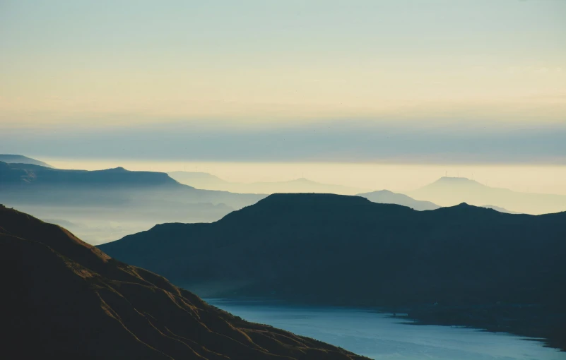 an image of mountains that are fog in the air