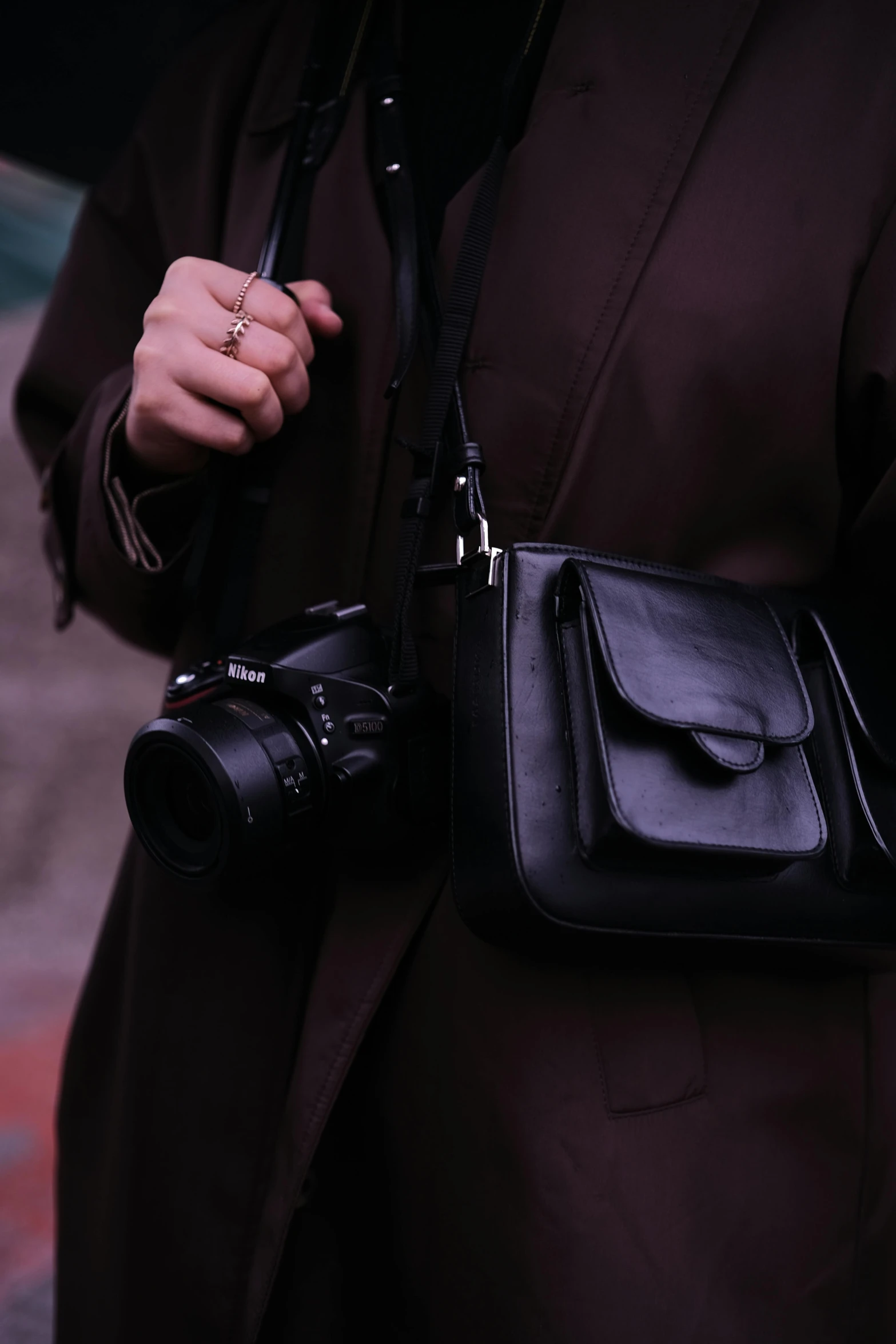 a woman holding a camera in her right hand