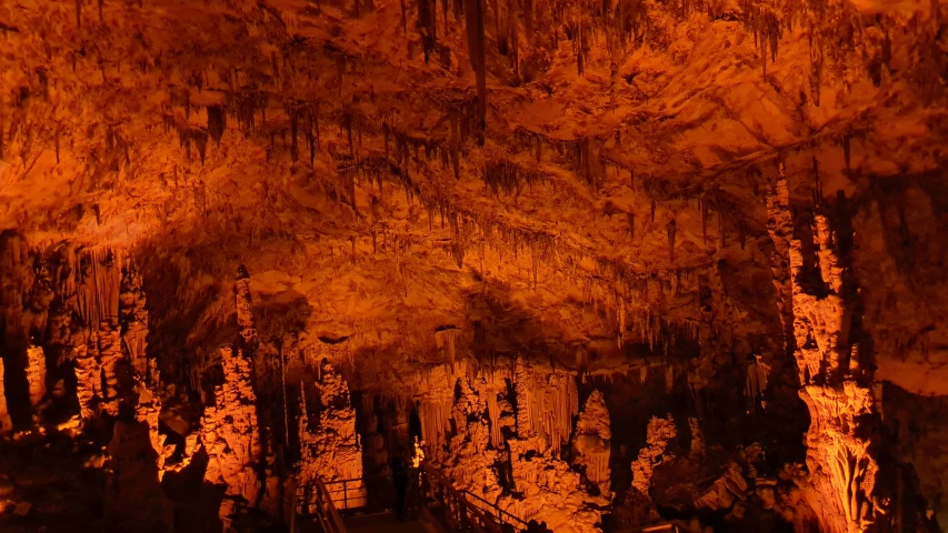 a lit cave with a large amount of dark and brown things