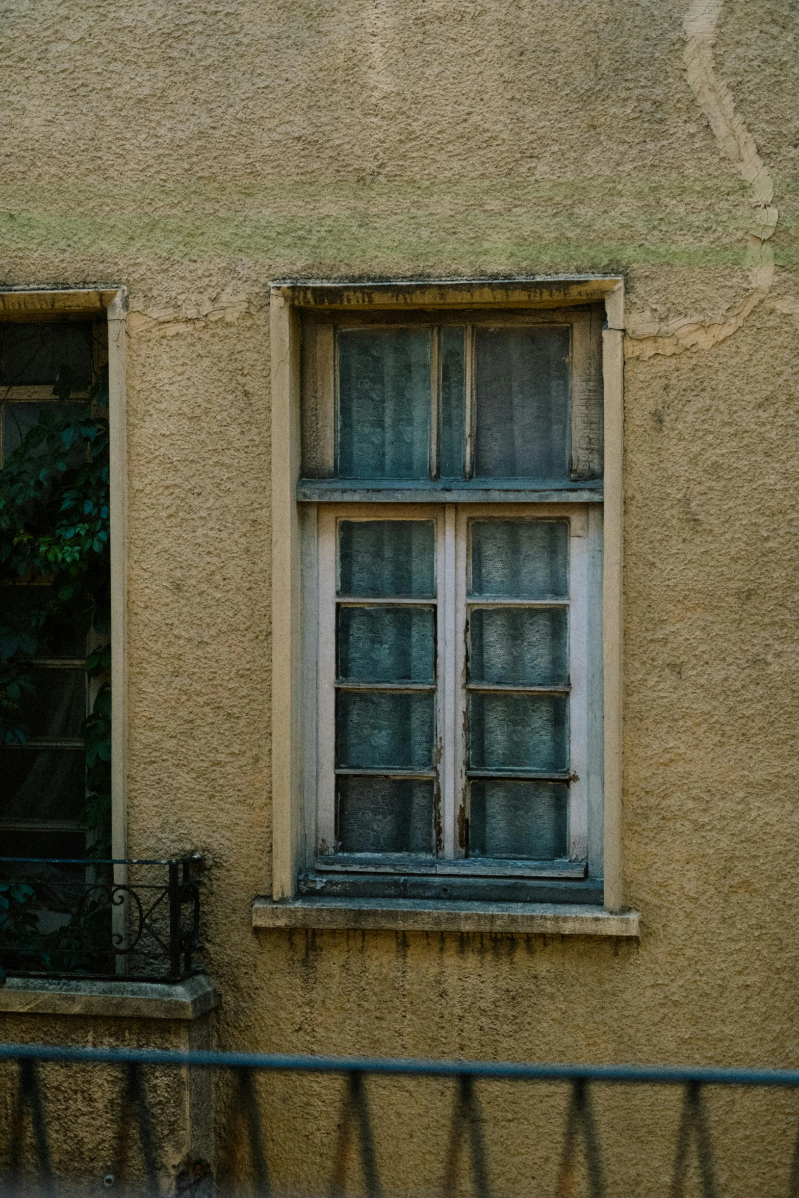 a window and door on a beige building