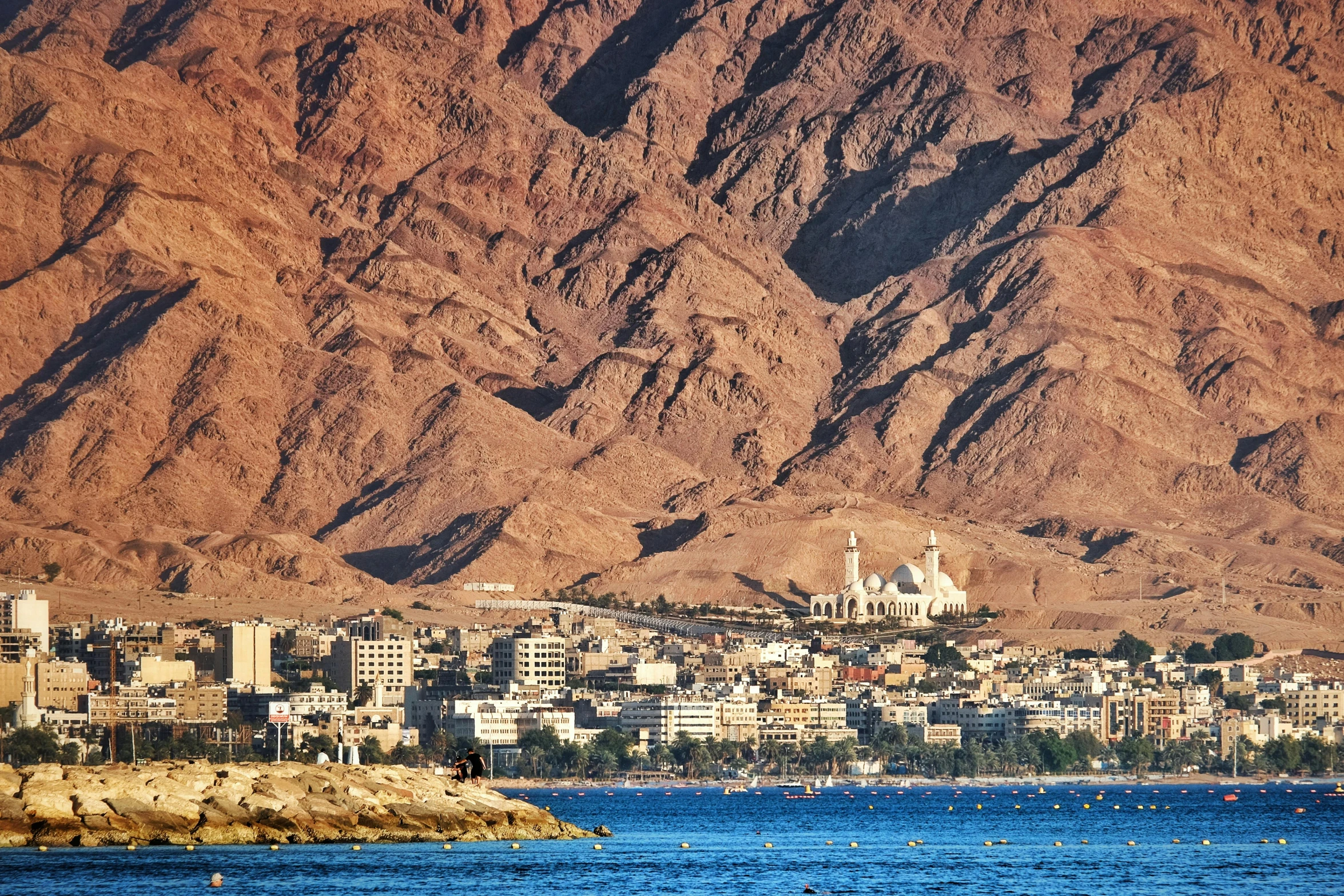 some water and a mountain and buildings