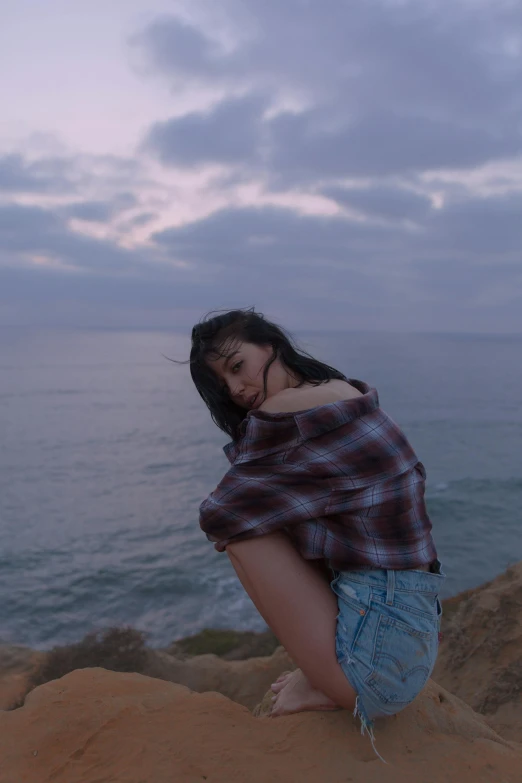 a woman kneeling down on top of a rock