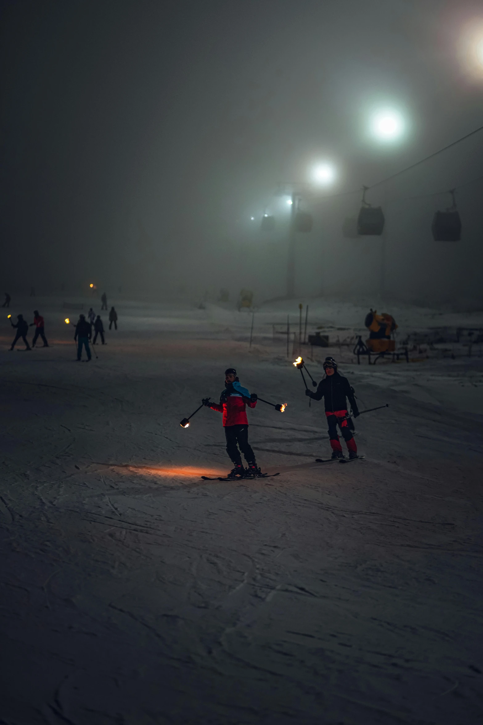 two people standing together holding up their skis