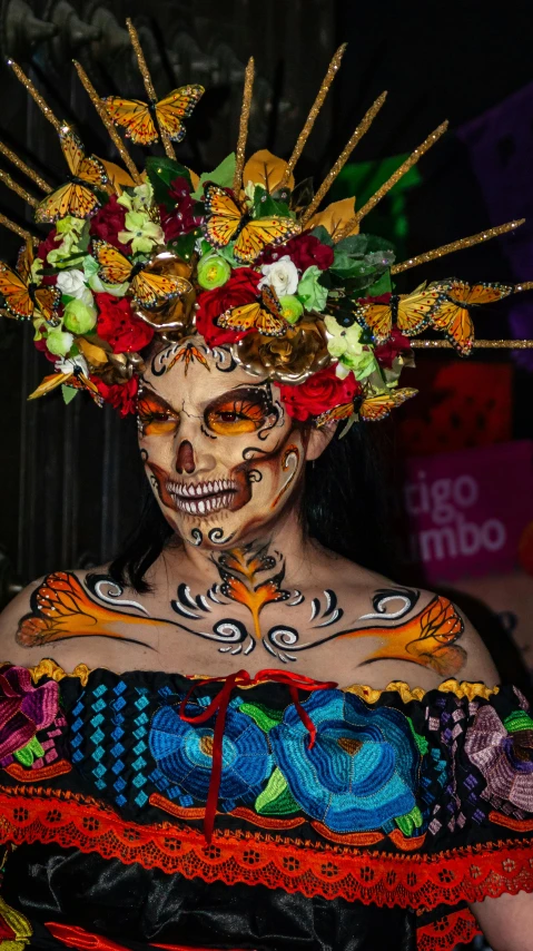 a woman with makeup and hair wearing a head piece