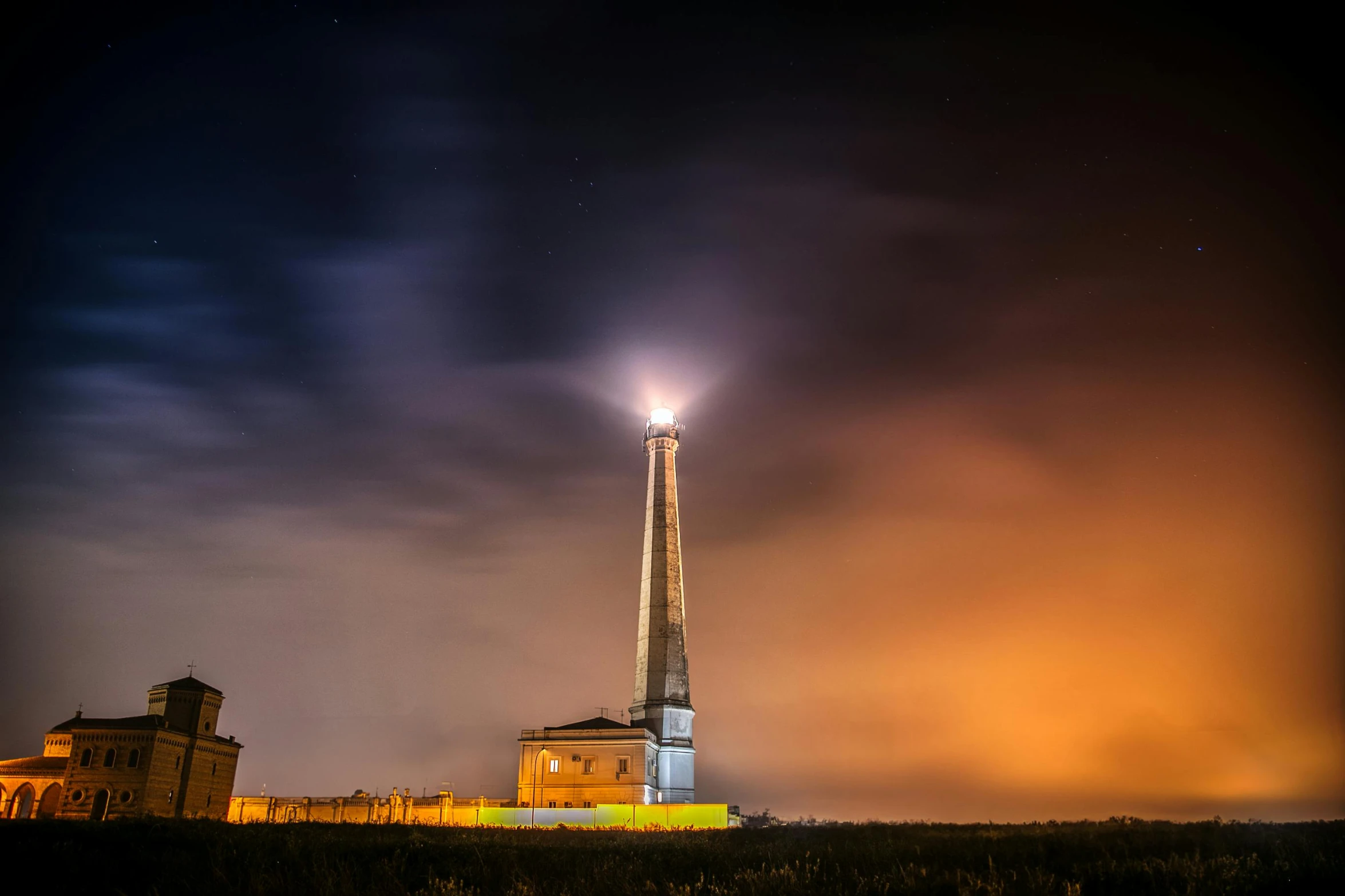 the bright tower is illuminated in the dark sky