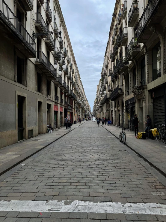 a narrow brick street with bicycles parked on it