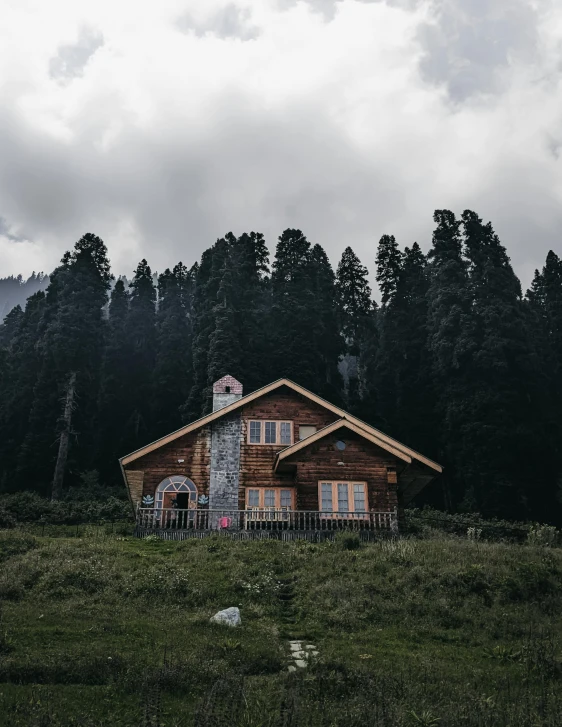 a large wood cabin surrounded by tall pine trees