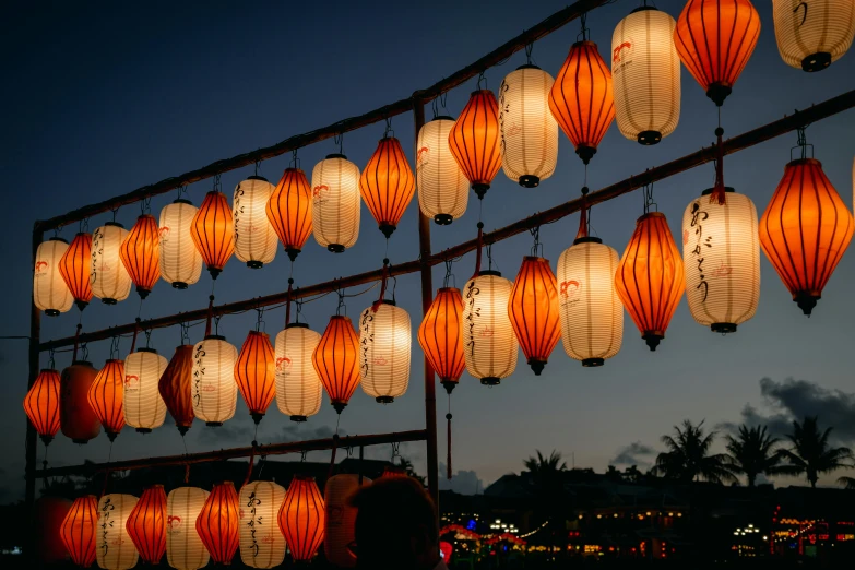 large string with many different color paper lanterns attached