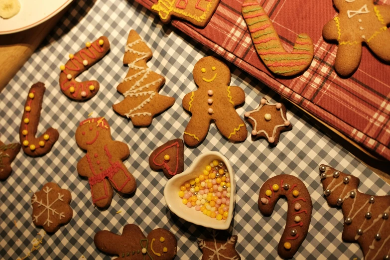 cookies and desserts are spread out on a checkered table cloth