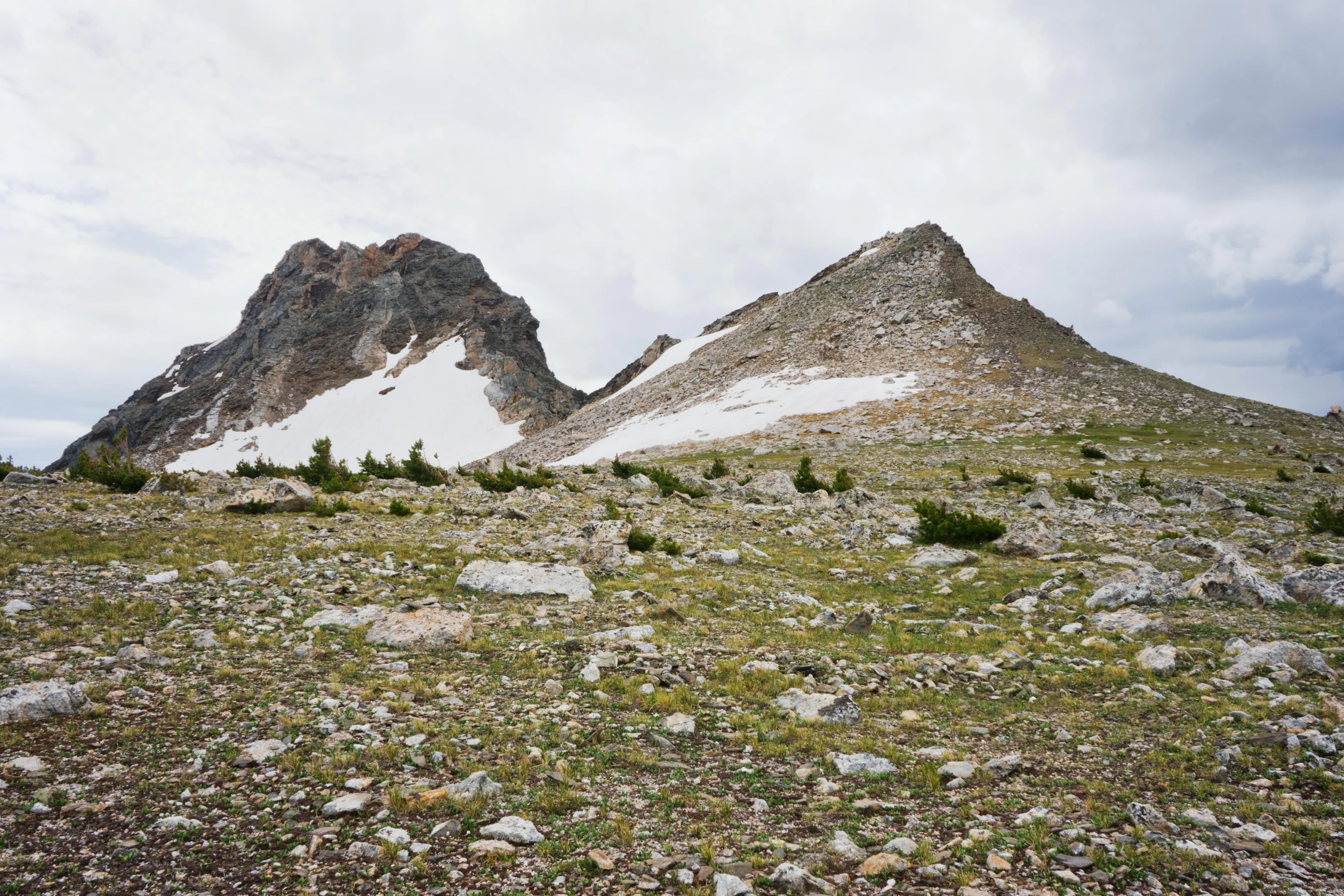 several small rocks and boulders dot a mountain