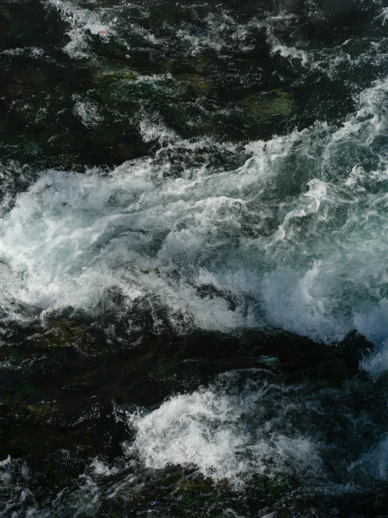 an area with very close waves near a body of water