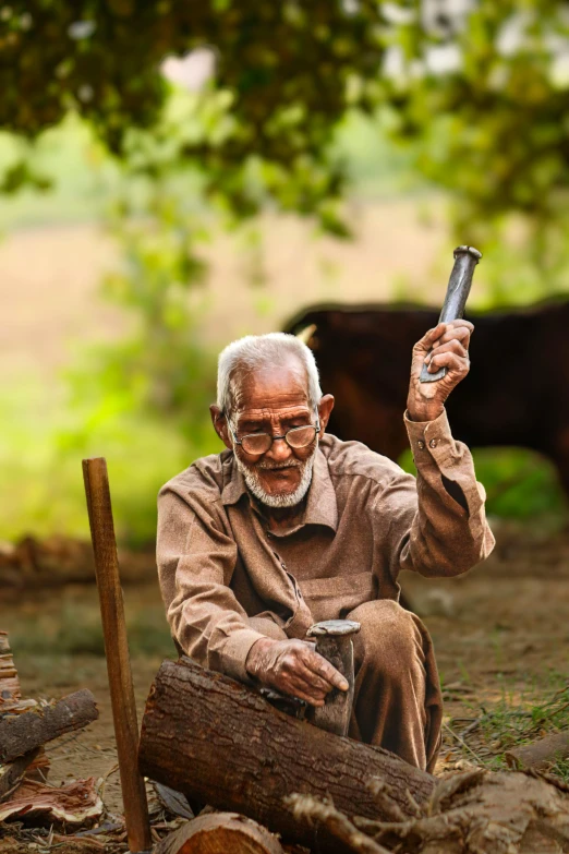 a man holding up his hand in front of cows