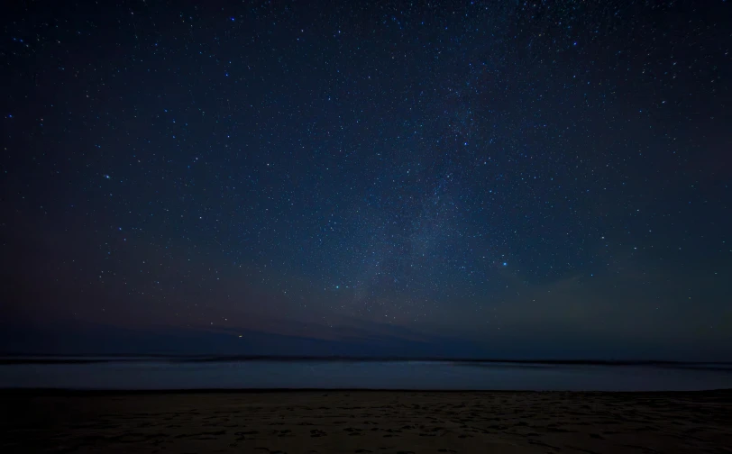 stars in the night sky over the water