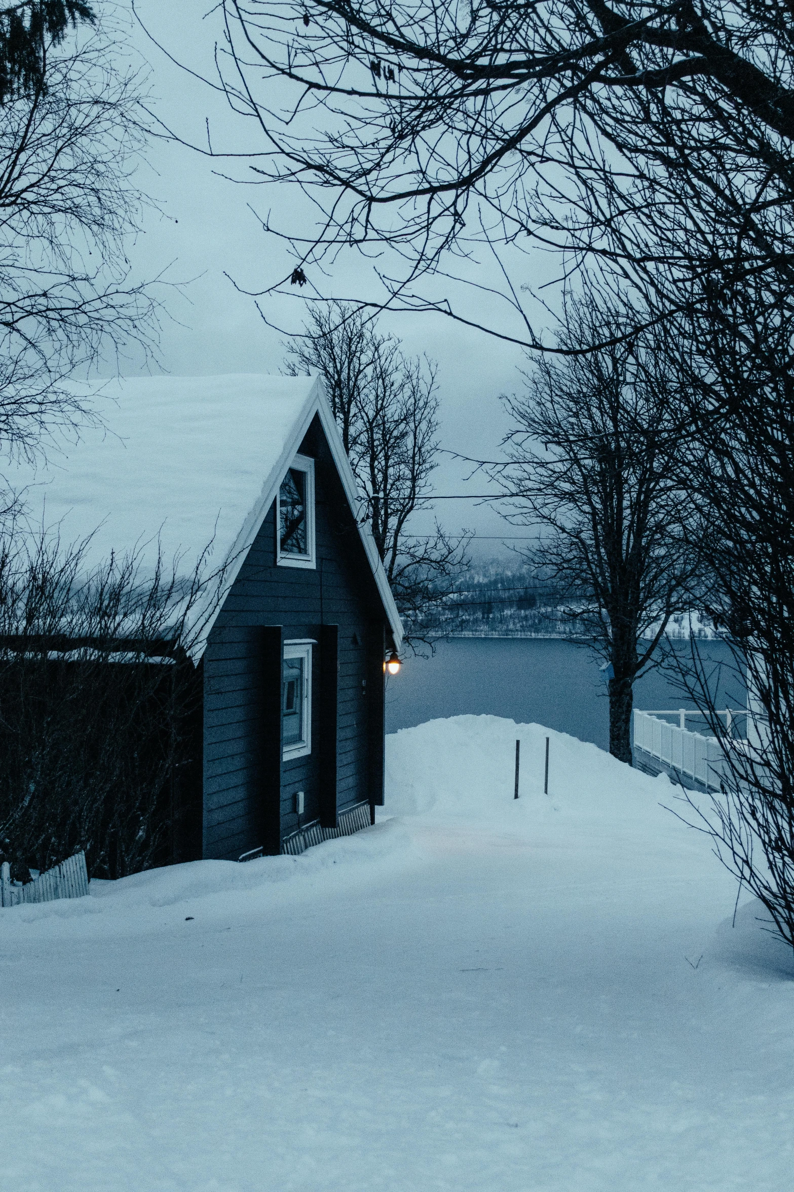 a small shed on a snow covered hill