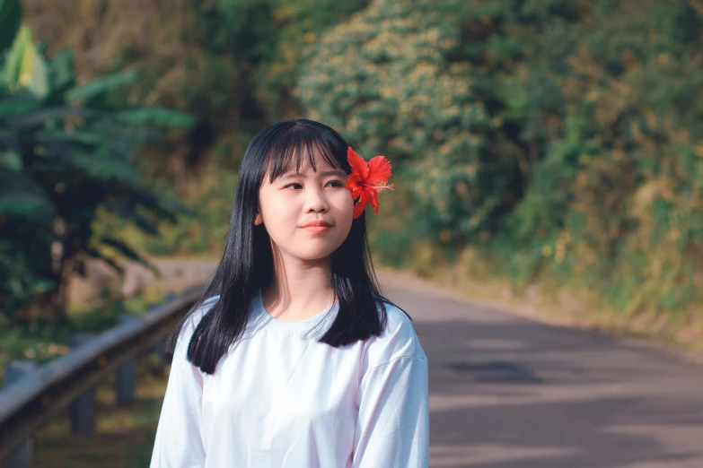 a woman standing on the side of a road