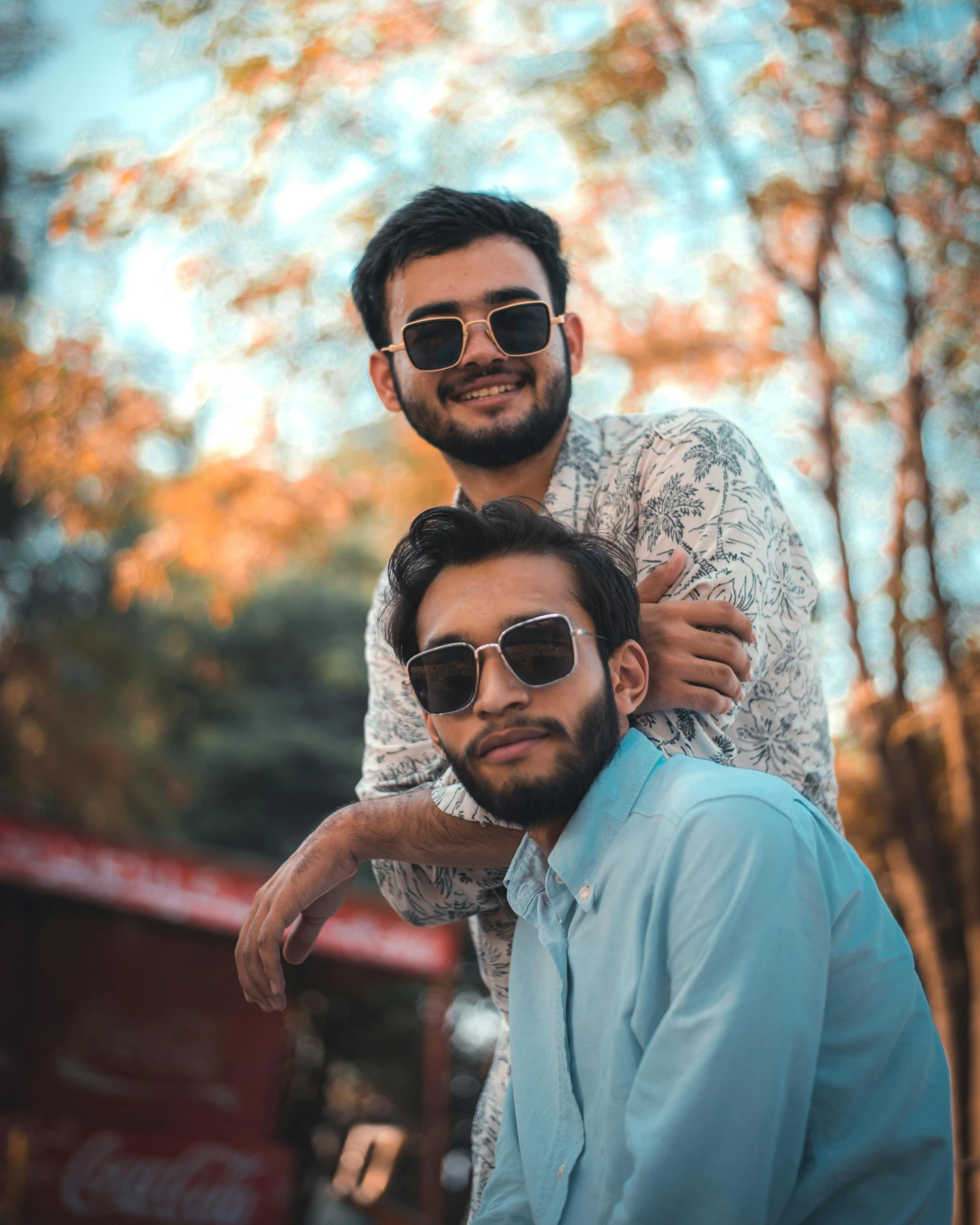 two men pose for the camera wearing sunglasses