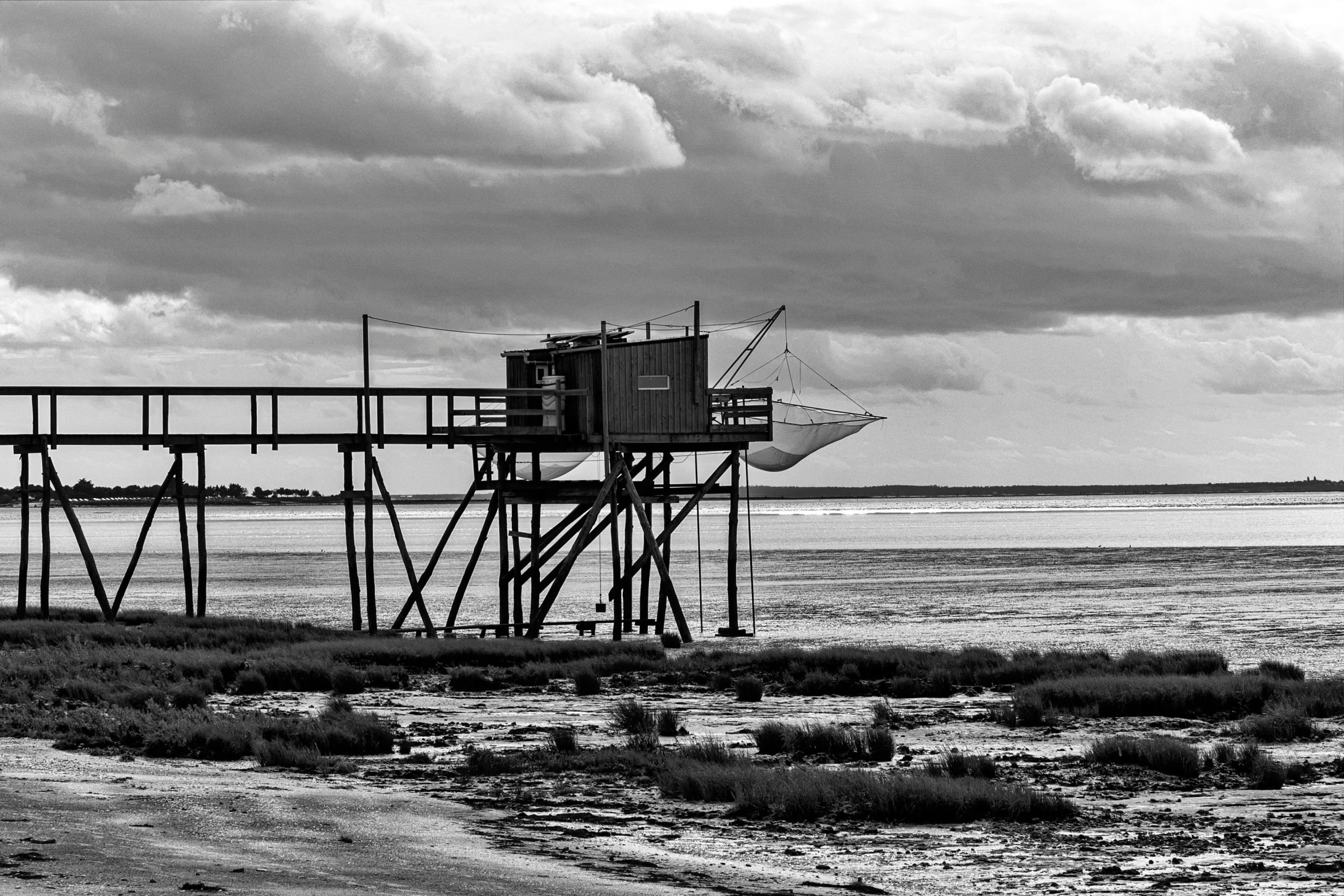 a boat traveling past a structure in the ocean