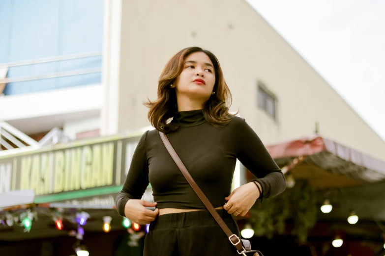 a woman in black holding onto her purse