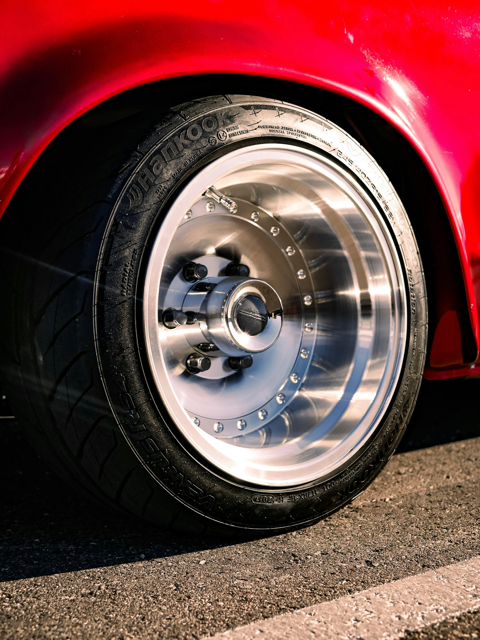 a close up of the wheel of a sports car