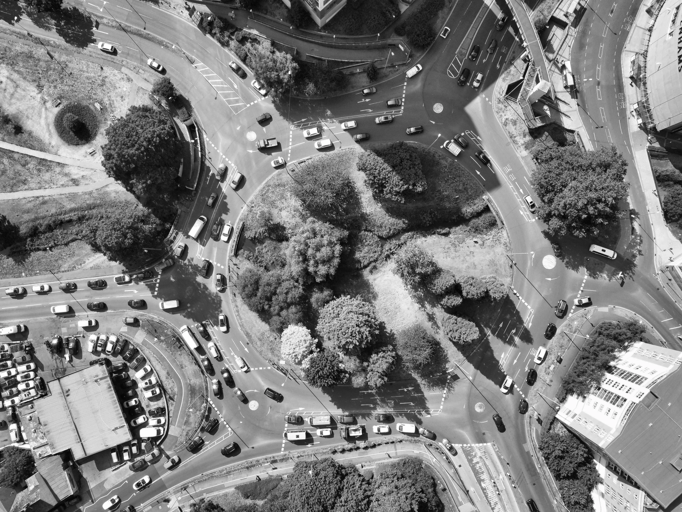 an aerial view of an intersection with cars and buses