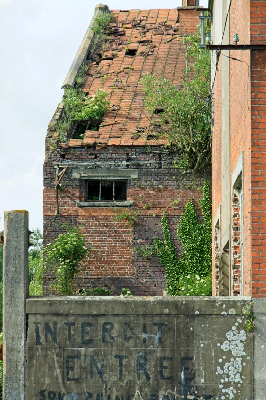 an old sign is shown by some brick buildings