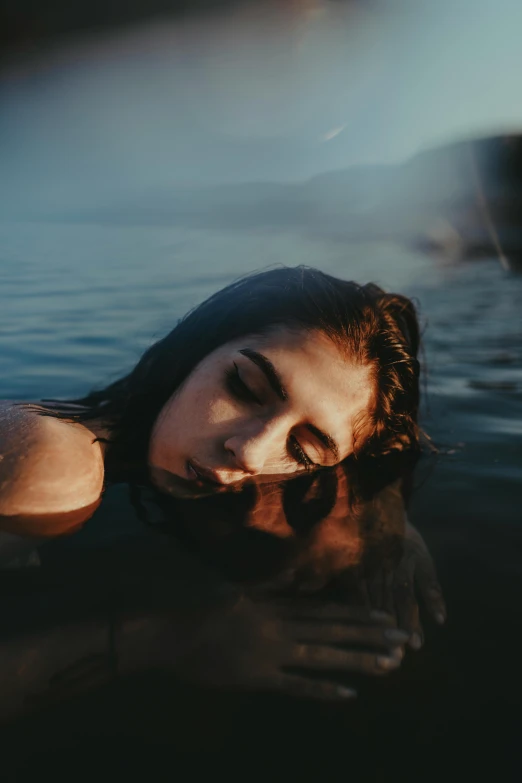 woman swimming in the water near a boat