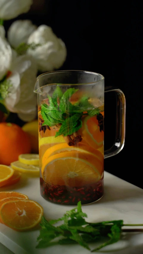 a pitcher of orange and ginger tea on a table