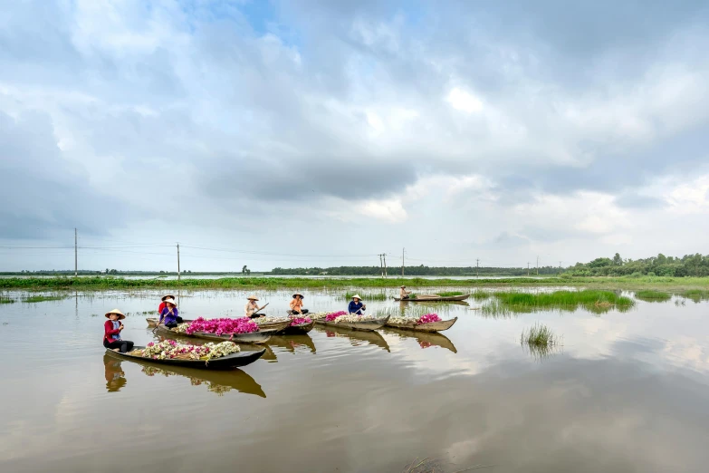 two canoes are floating on the water with a lot of people standing on it