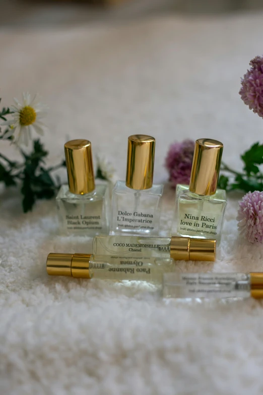 three different bottles of small, gold capped glass for perfumes