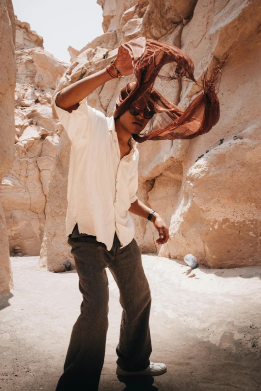 a man is standing in the middle of some big rocks