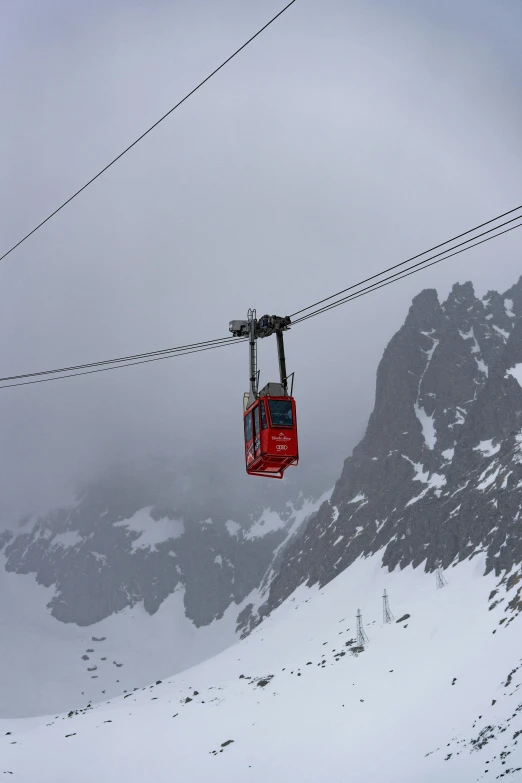 ski lift with mountain in background with white snow