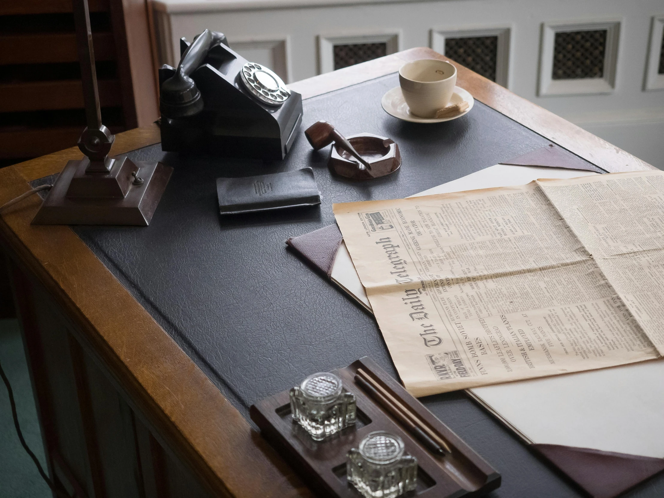 a table topped with an open book and a cell phone