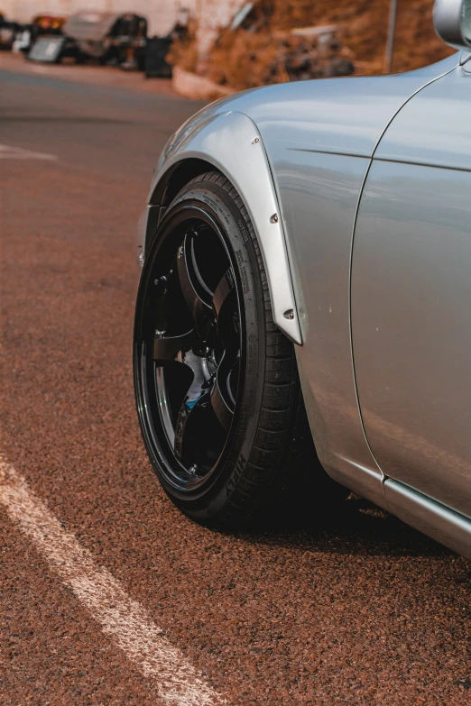 the tire on this car is parked on the street