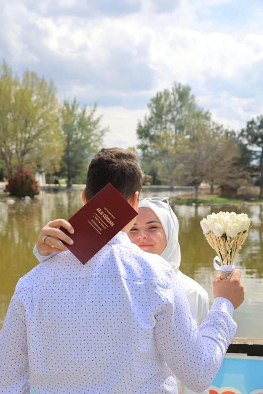 a woman is holding flowers and an electronic passport