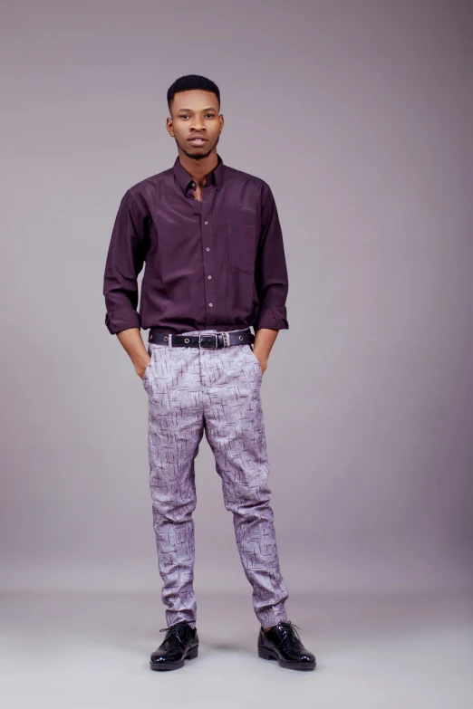 a man standing in front of a gray background