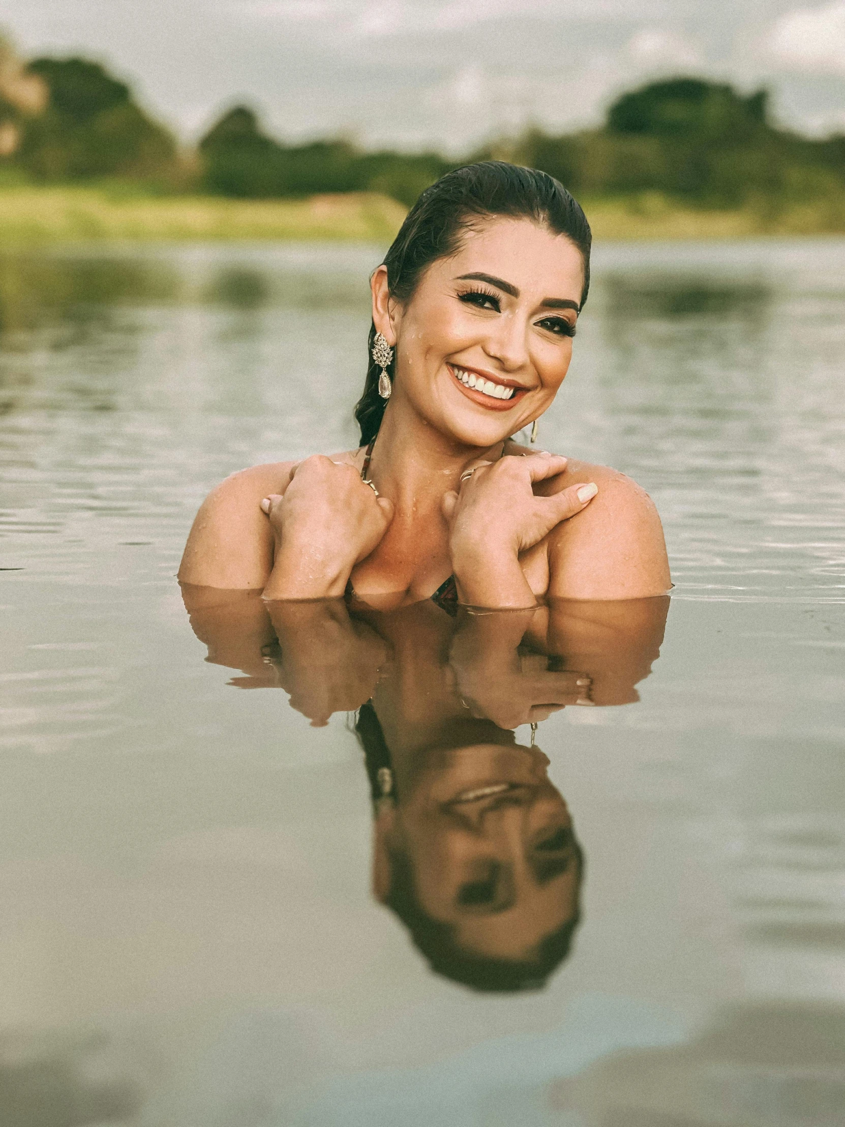 a girl laying down on her stomach in the water