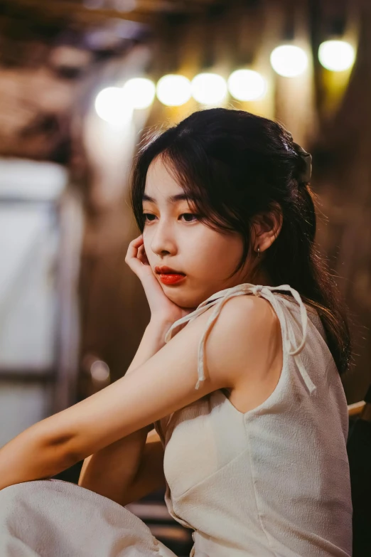 asian woman in white dress looking off camera