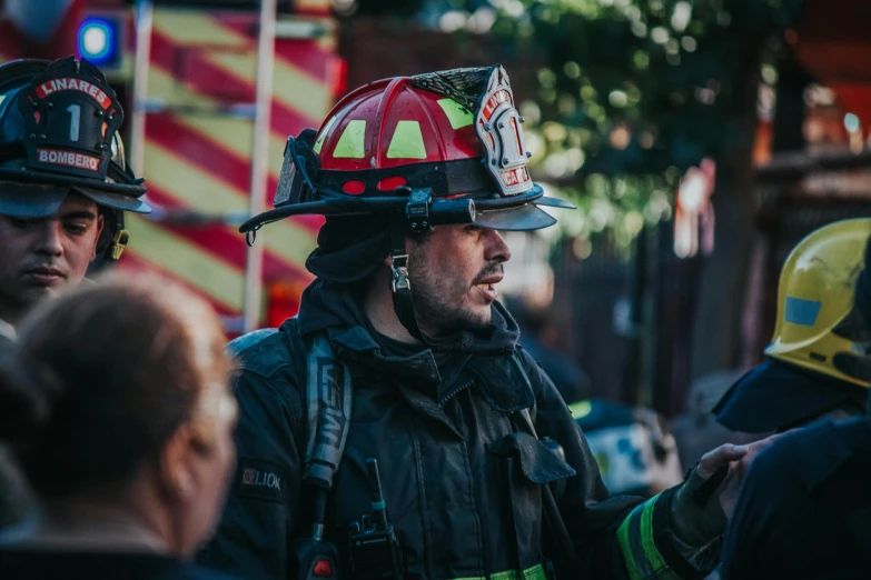 two firemen in full helmets walking together