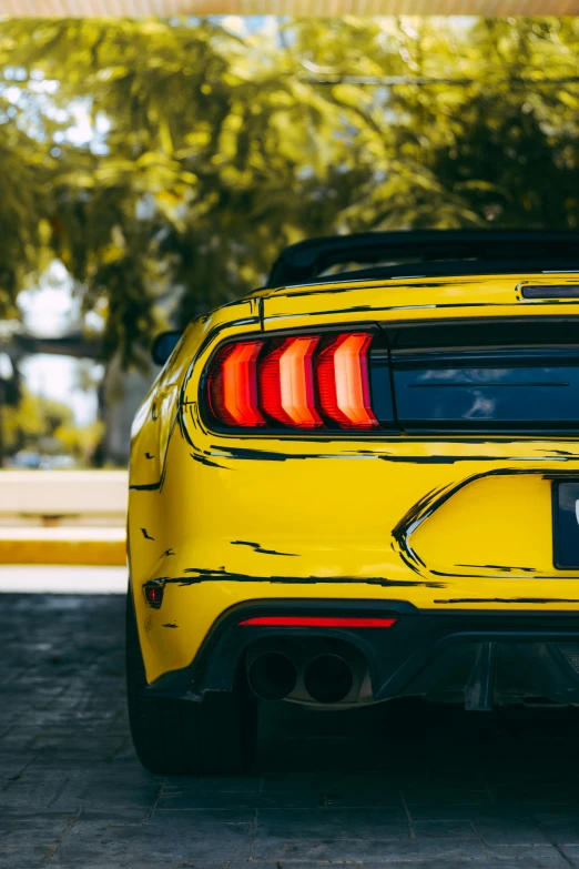 the rear end of the sports car shows the bright yellow color